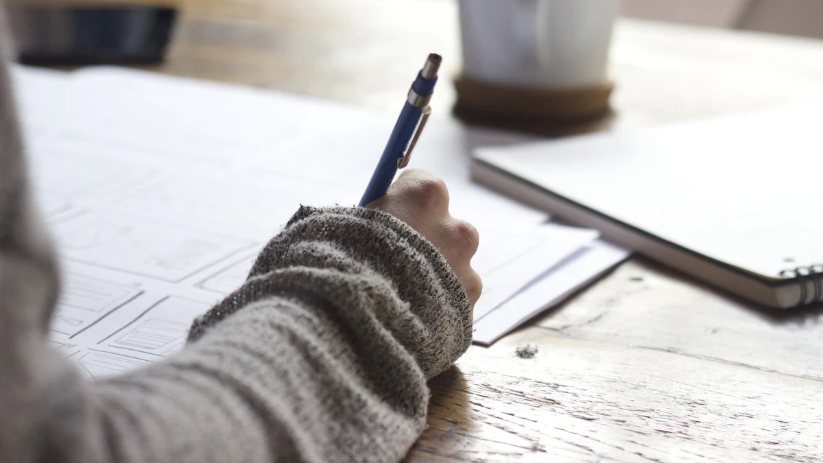 Writing up invoices by hand at a desk with a notebook and coffee